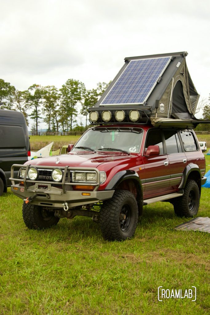 Toyota with rooftop tent parked in the campground at Overland Expo East 2021 in Arrington, Virginia.
