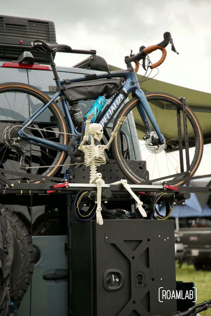 Skeleton posed on bicycle rack of rig at Overland Expo East 2021 in Arrington, Virginia.