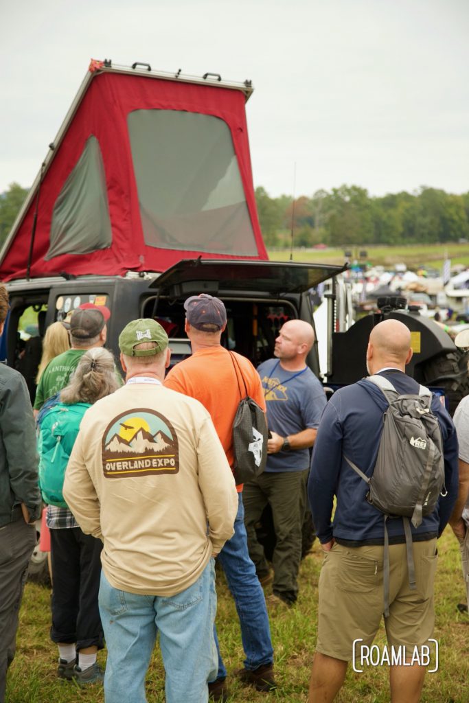 Man lecturing a crows about his popup overland rig at Overland Expo East 2021 in Arrington, Virginia.