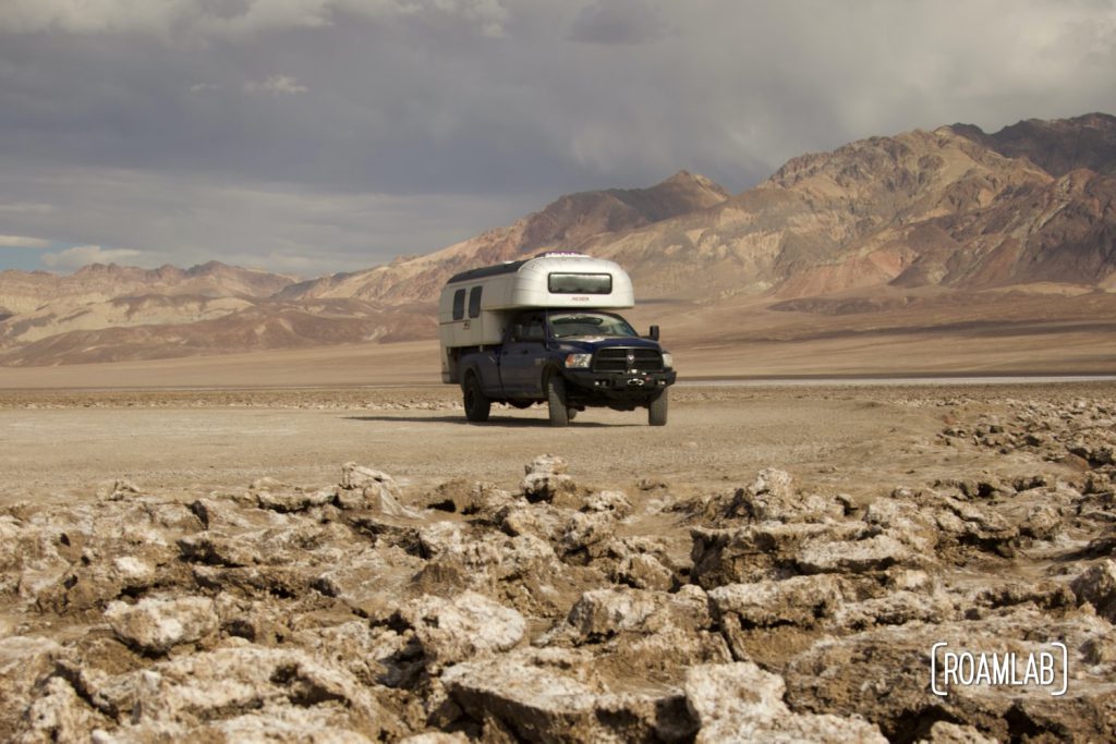 1970 Avion C11 truck camper parked in the Devil's Golf Course with the Amargosa Range in the background.