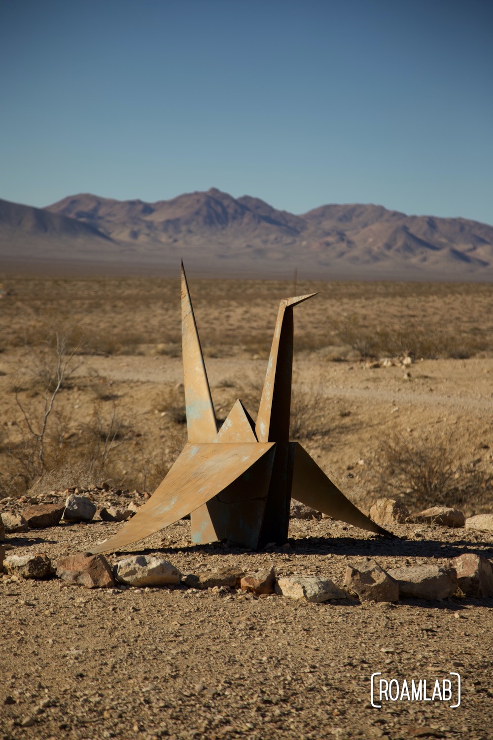 Giant origami crane composed of folded sheet metal located in the Nevada desert.