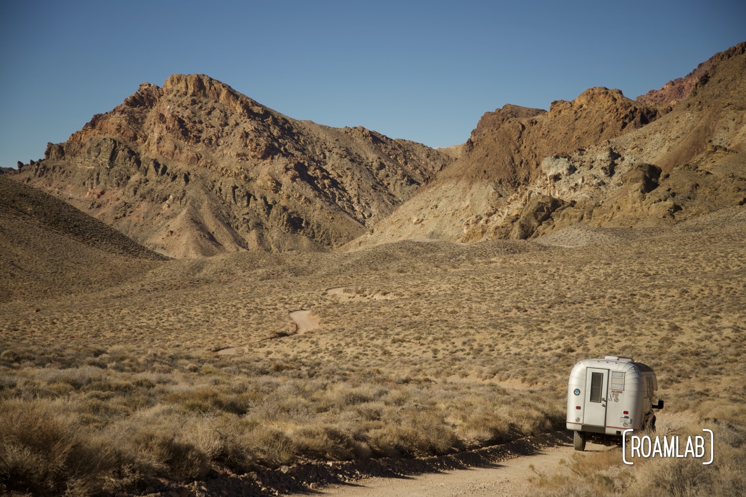1970 Avion C11 truck camper following the dirt Titus Canyon Road in Death Valley National Park, California.