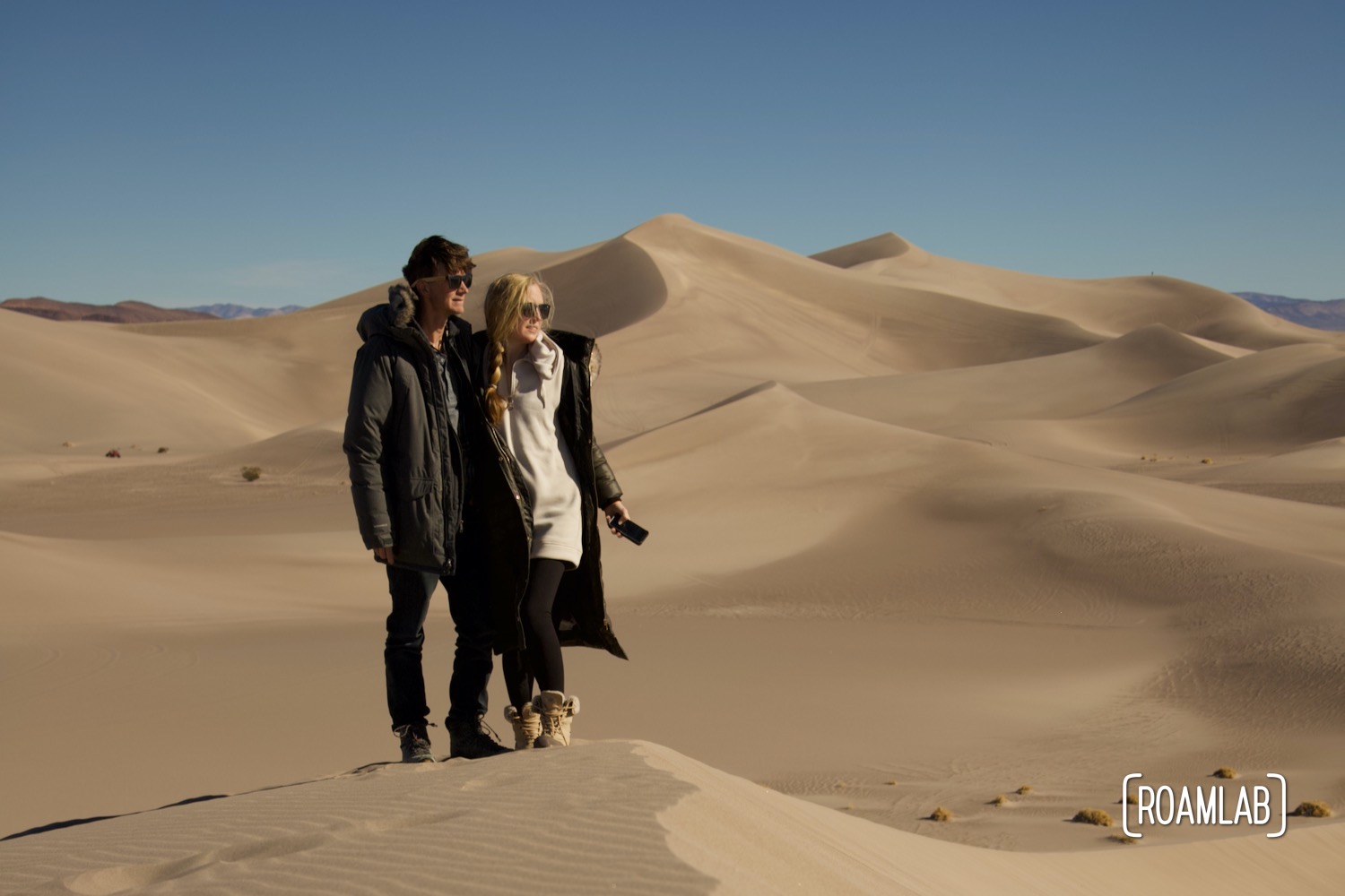 Couple looking out over Big Dune Recreational Area in Nevada.