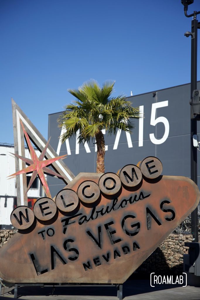 Dystopian "Welcome to Fabulous Las Vegas Nevada" sign rusting on its side in front of Area 15.