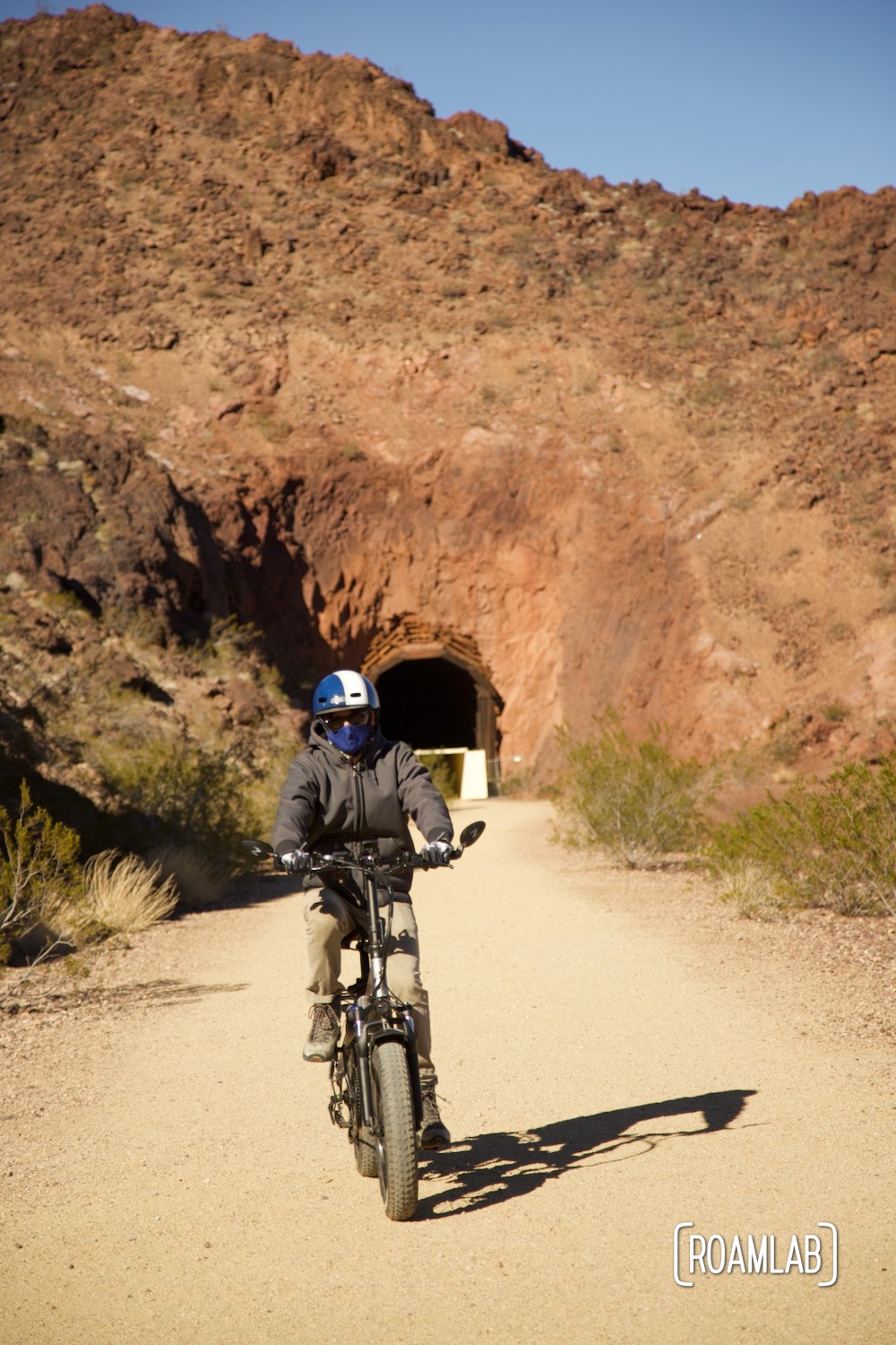Man biking through one of five tunnels on Tunnel Trail in Lake Mead National Recreation Area