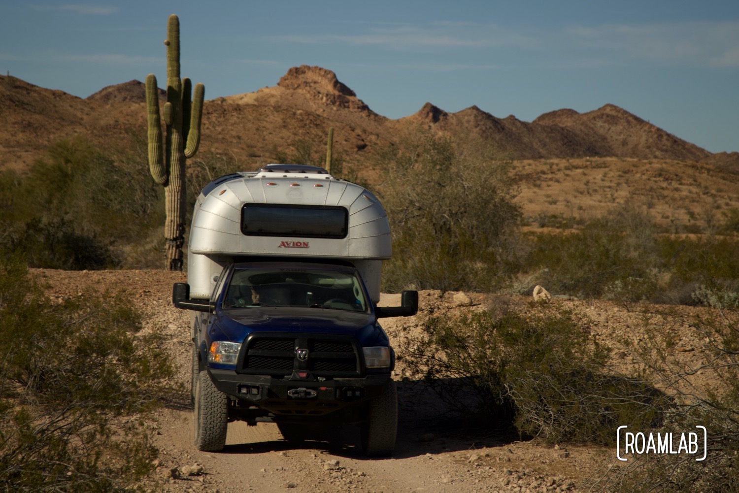 Avion C11 truck camper navigating a rocky dirt Castle Dome Mine Road in Kofa Wilderness Refuge.