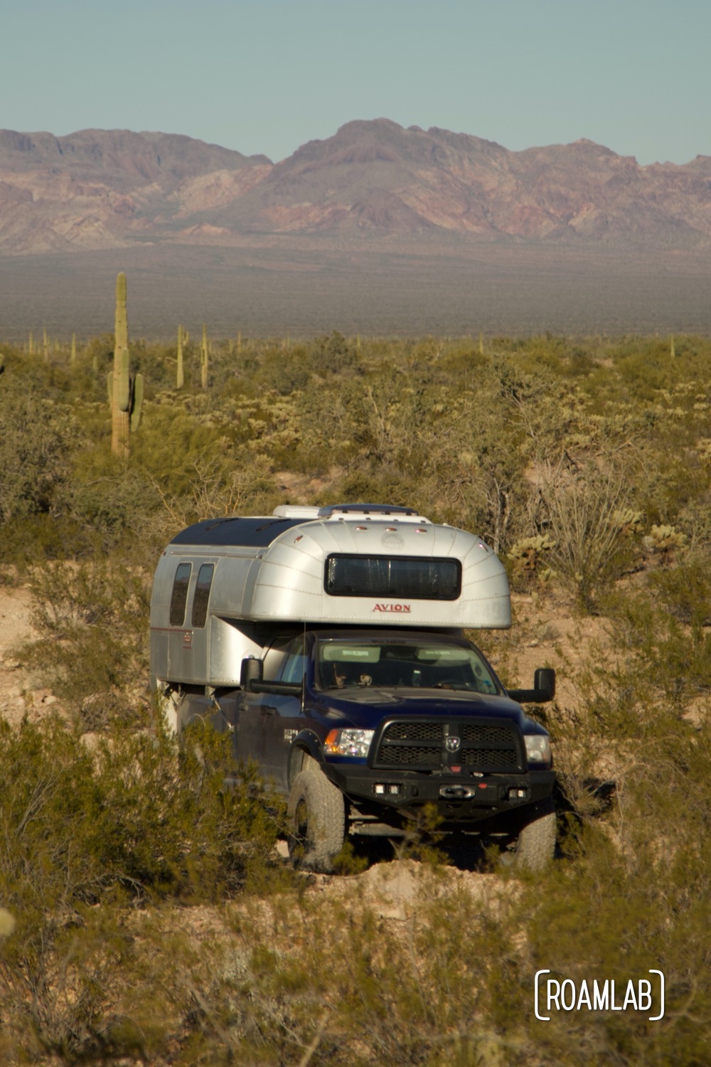 Avion C11 truck camper navigating a rocky dirt Castle Dome Mine Road in Kofa Wilderness Refuge.