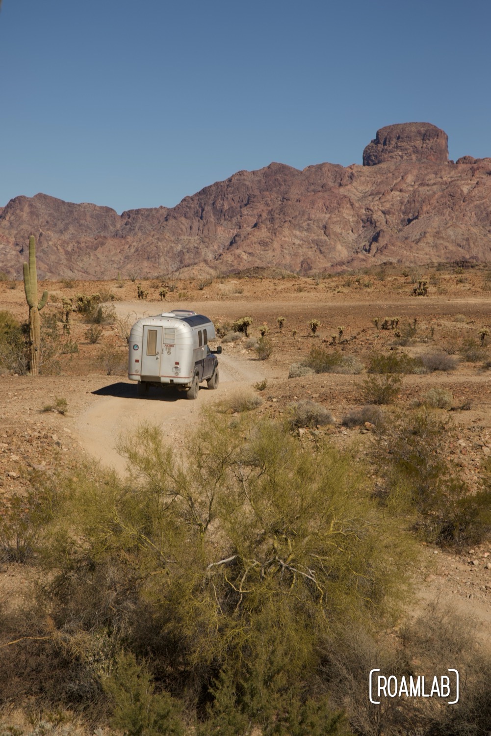 Avion C11 truck camper navigating a rocky dirt Castle Dome Mine Road in Kofa Wilderness Refuge.