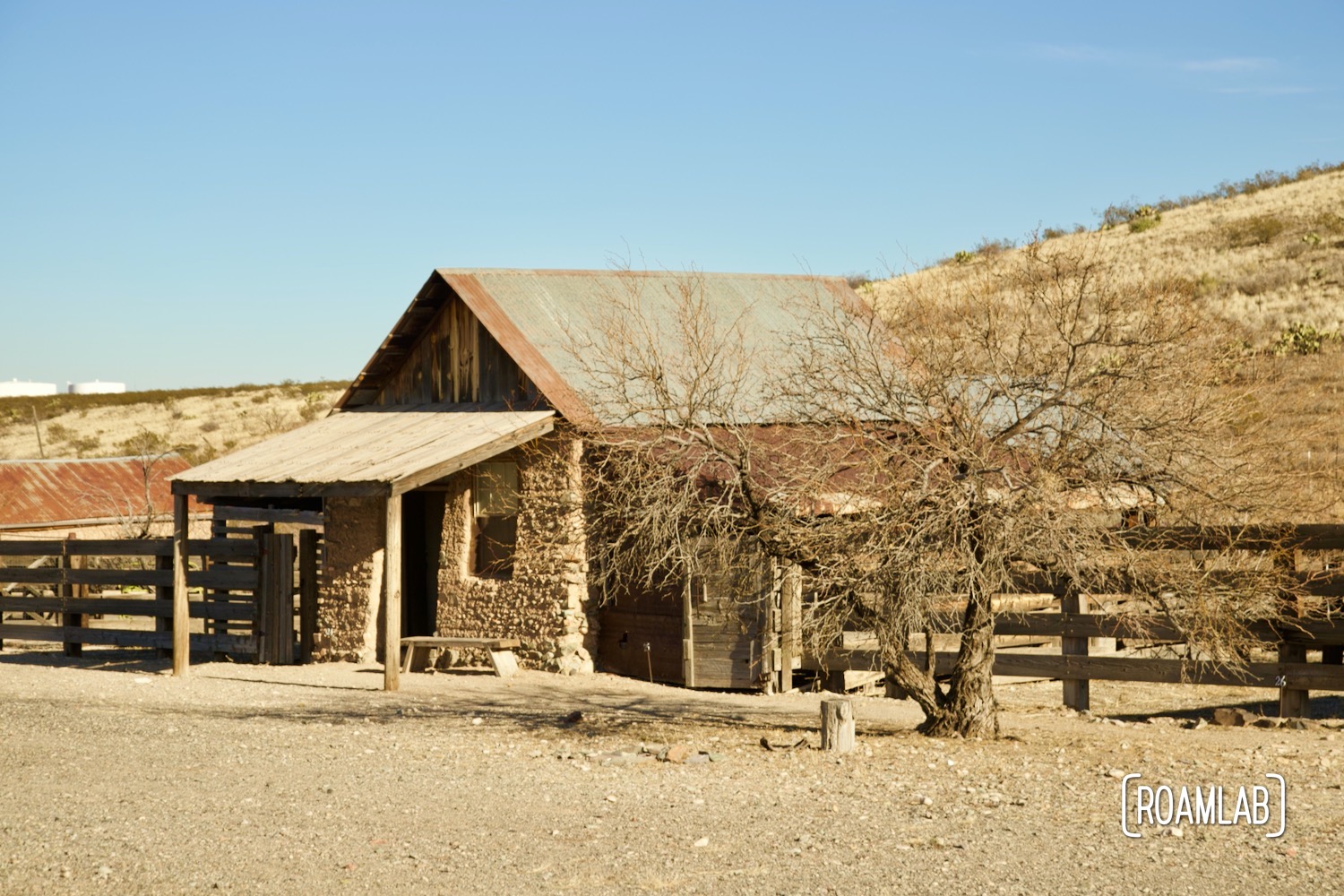 Old homestead on a dry grassy hill in Shakespeare Ghost Town, New Mexico.