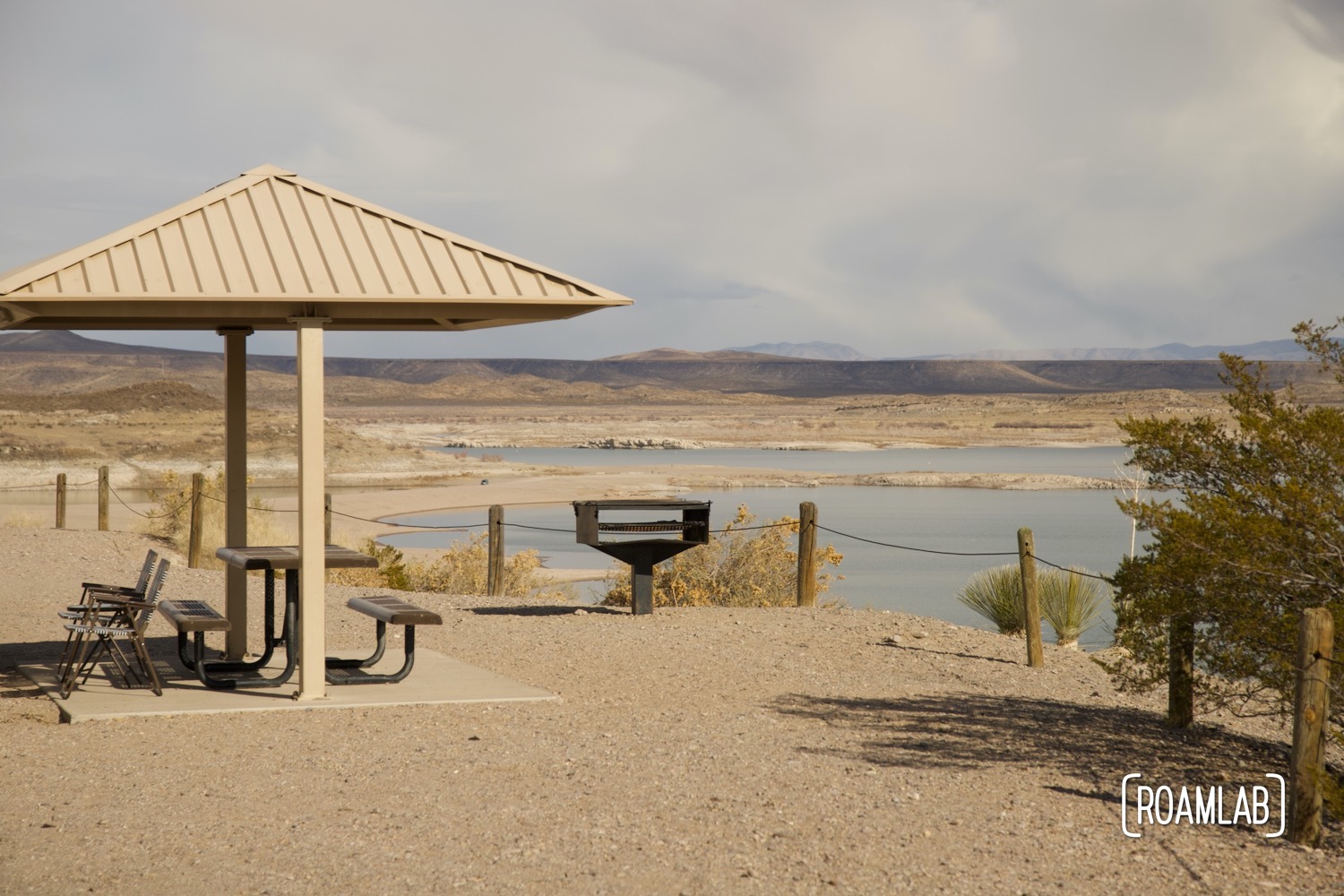 Covered picnic table and grill positioned on a ridge overlooking Elephant Butte Lake.