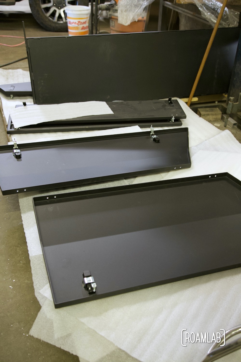 Storage box hatches ready to be installed on a Bowen Customs aluminum truck bed.