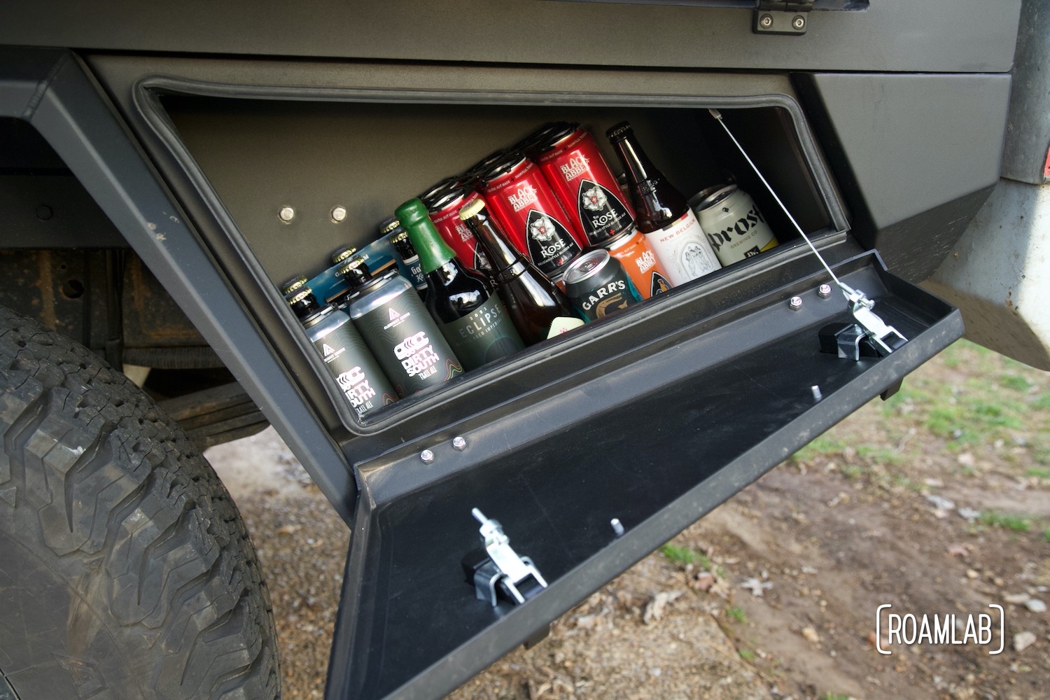 View in a Bowen Customs truck bed lower rear storage box loaded with beer.