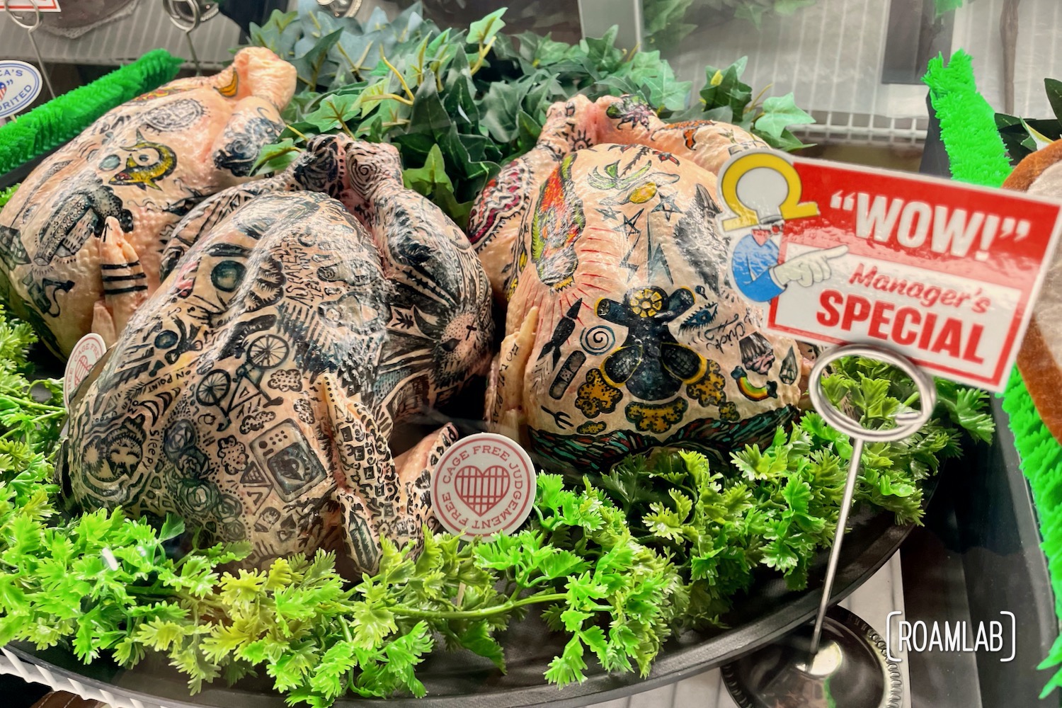 Three tattooed  chickens behind the meat counter in Omega Mart, Meow Wolf's Las Vegas location.