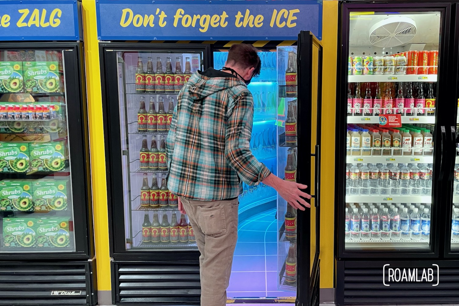 Man walking into a freezer in Omega Mart, Meow Wolf Las Vegas.