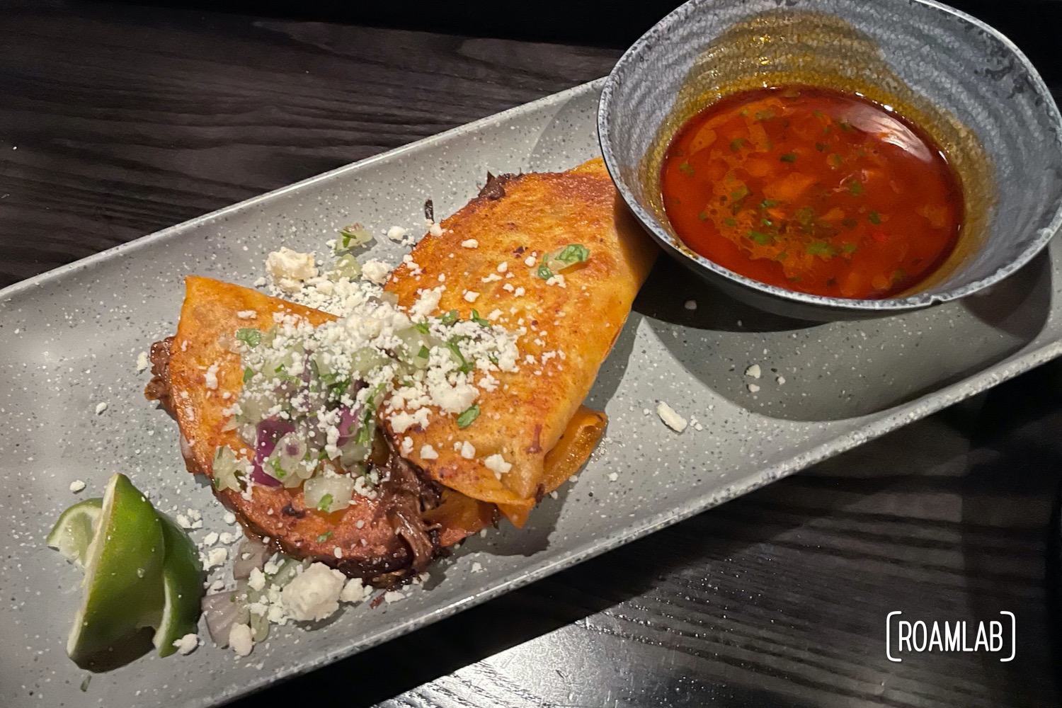 Tacos on a gray plate.