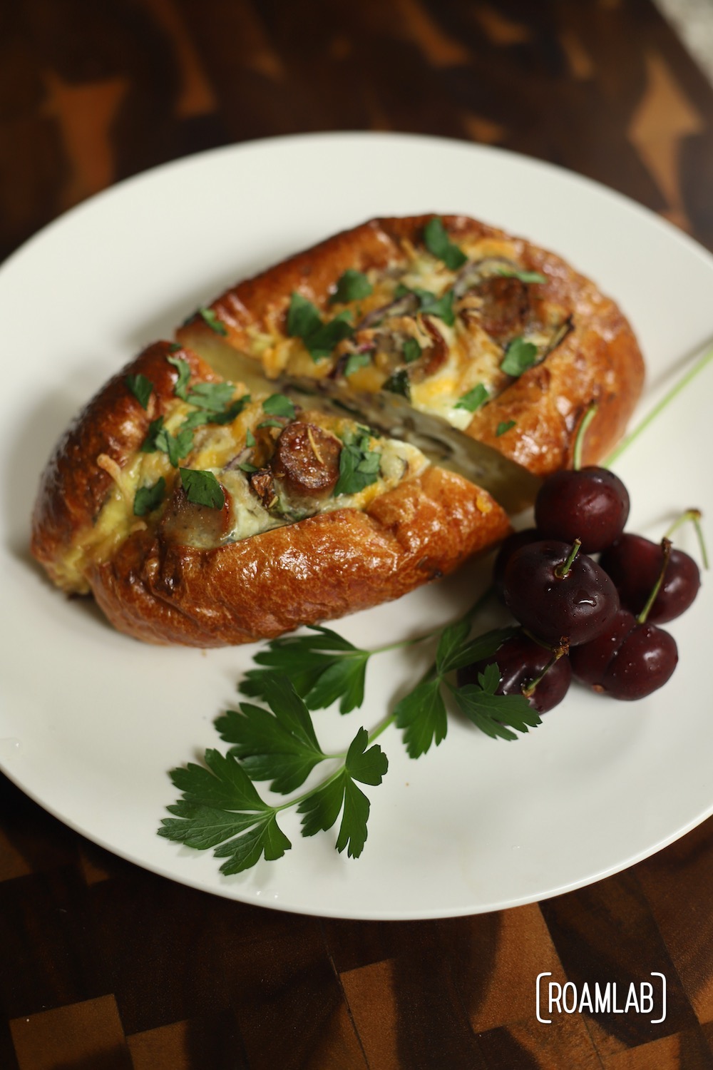 Egg boats on a white plate with a side of fresh cherries.