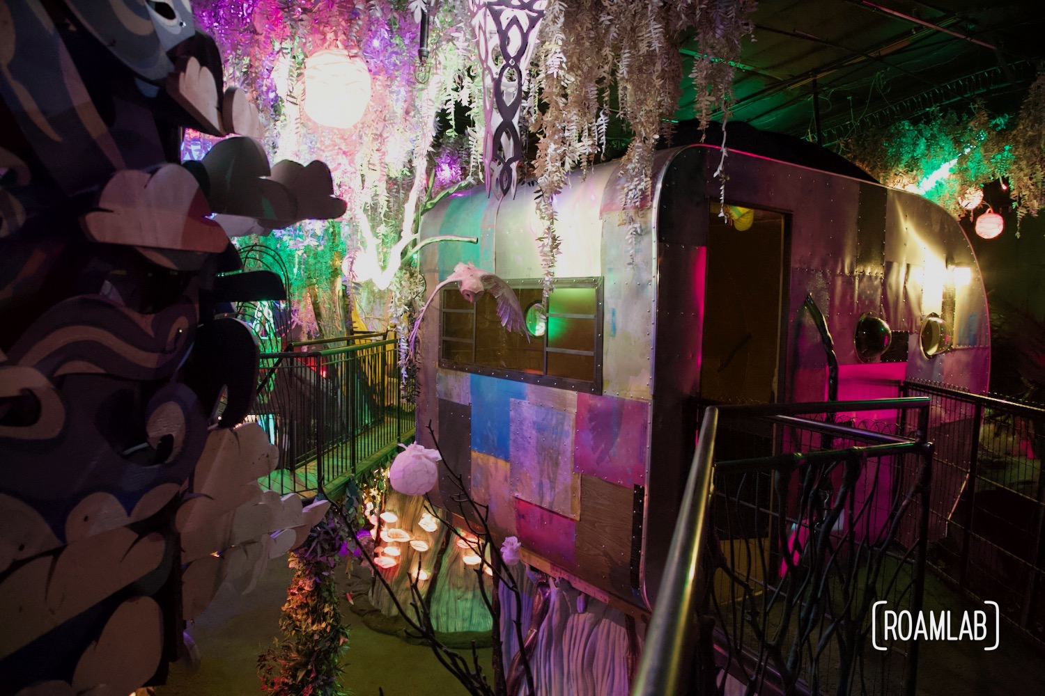 A colorfully patched RV suspended in a tree at the  House of Eternal Return, Meow Wolf's Santa Fe, New Mexico Location