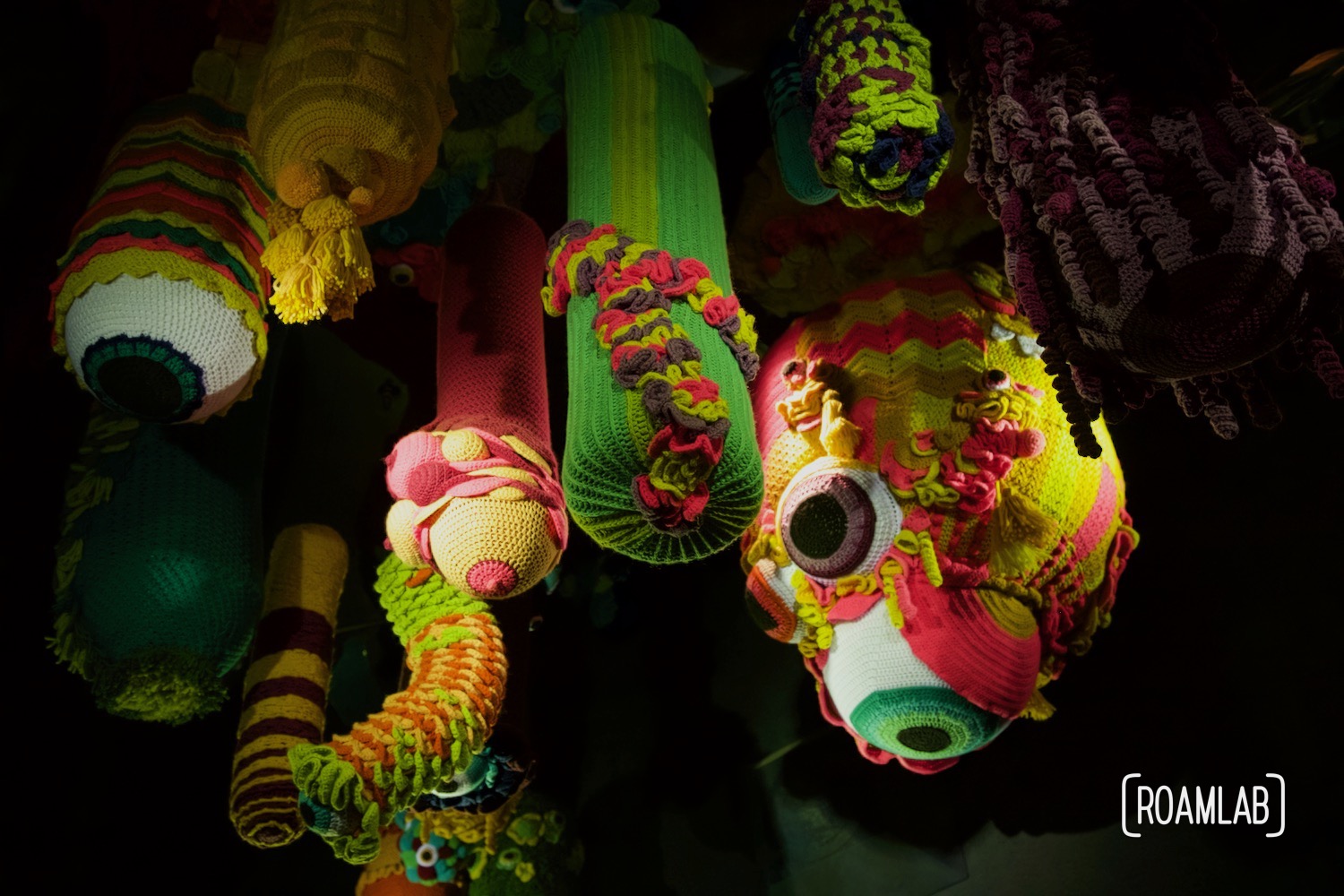 Surreal hanging crochet eye sculptures in Meow Wolf's Denver Colorado location, Convergence Station.