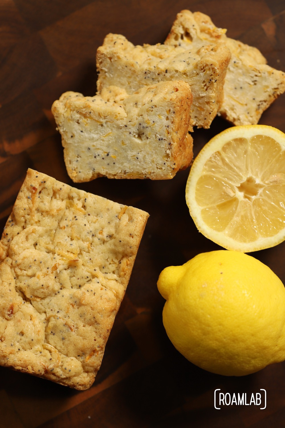 Lemon Poppyseed Squash Bread on a cutting board with lemons.