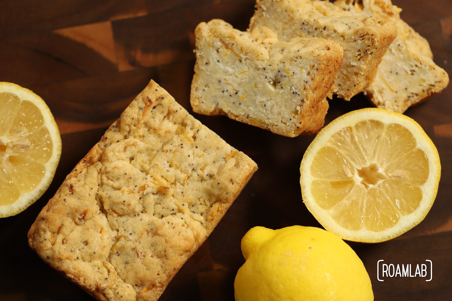 Lemon Poppyseed Squash Bread on a cutting board with lemons.