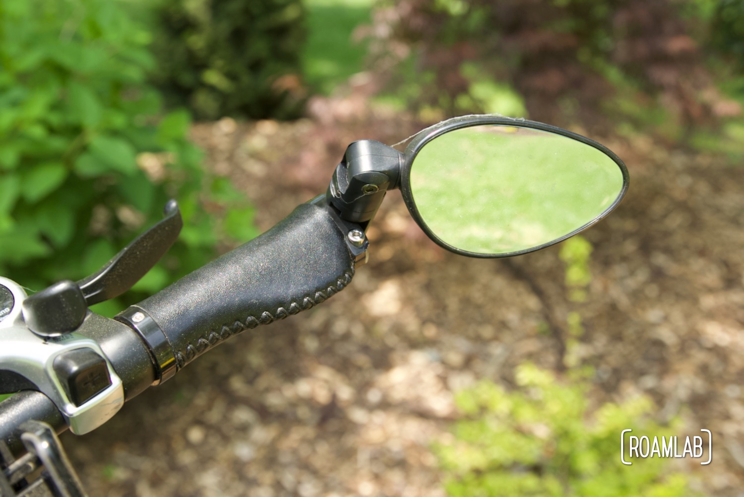 Rearview mirror mounted on bicycle handlebars.