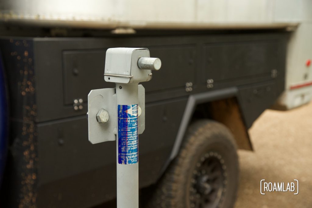Closeup of truck camper jack cleaned and coated with zinc galvanizing compound spray in front of a truck camper.