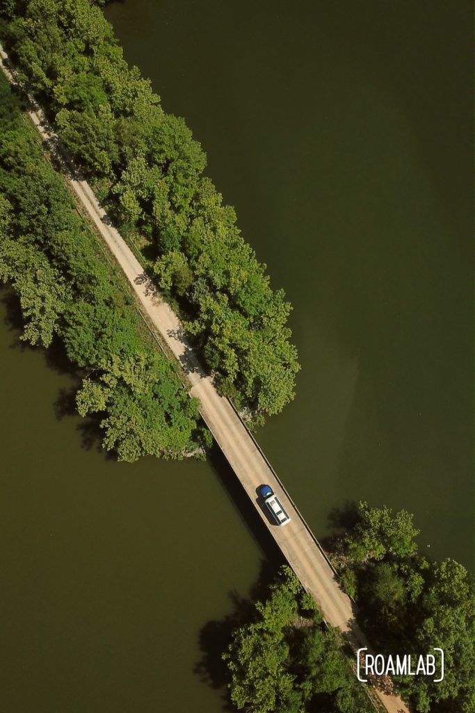 Avion truck camper crossing a bridige over Pryor Bay in Land Between the Lakes National Recreation Area.