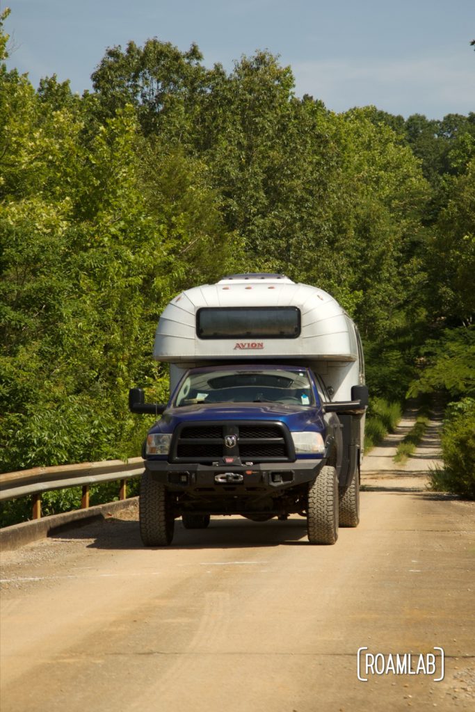 Avion C11 truck camper crossing a cement bridge.