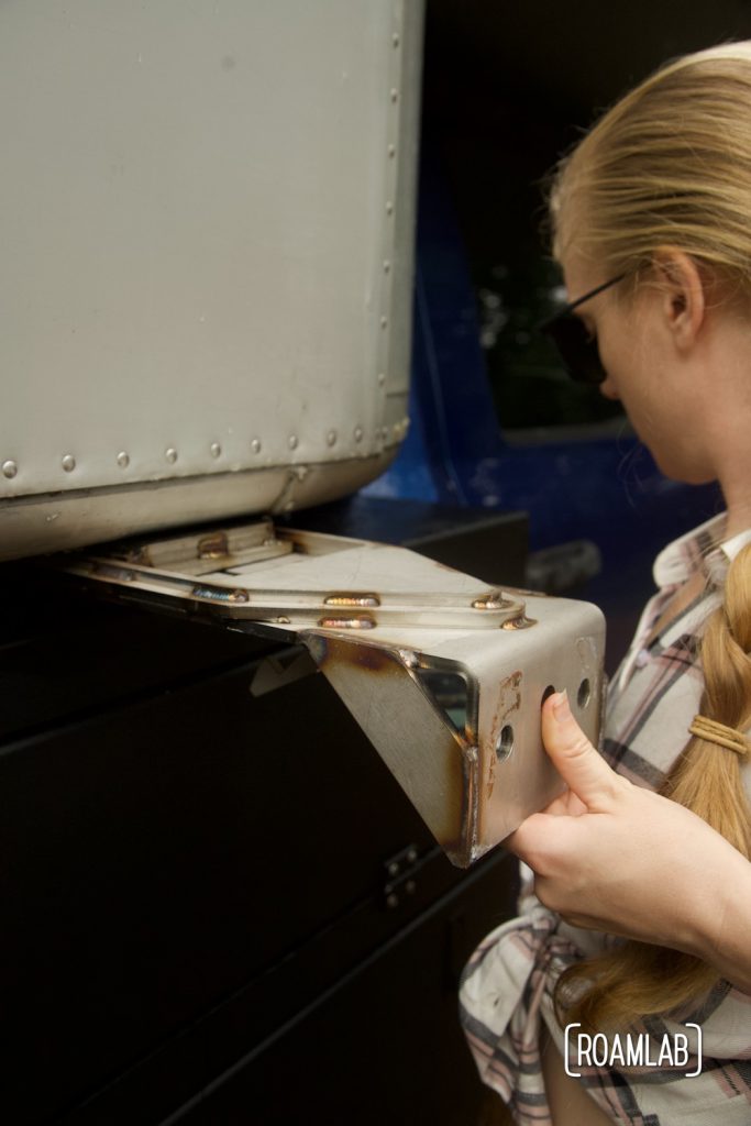 Woman sliding quick-release brackets into its mounting plate.