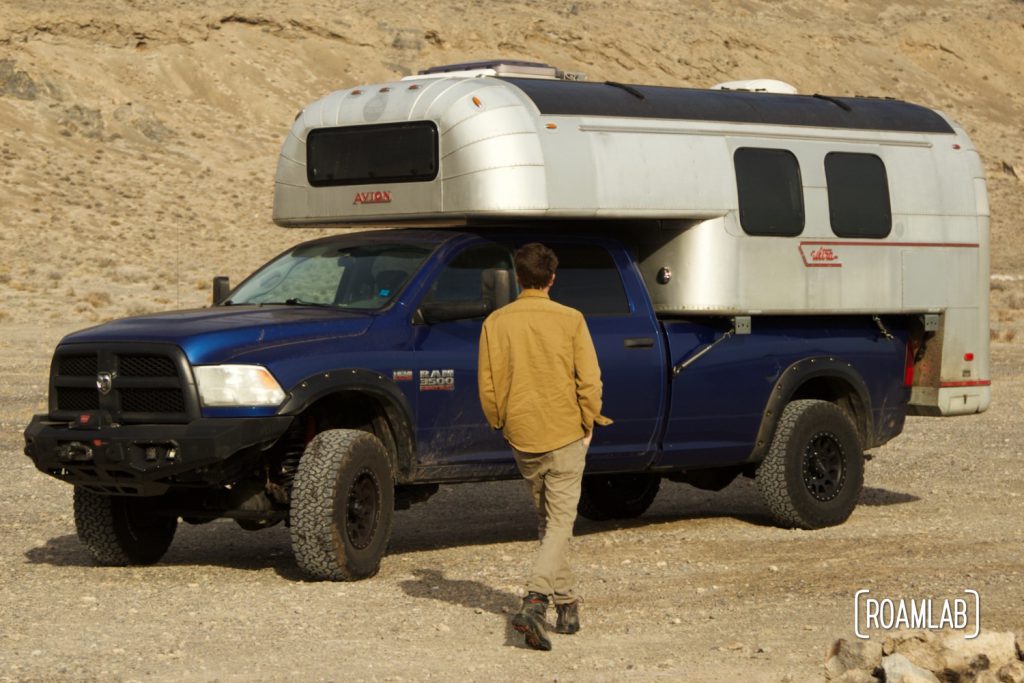 Man walking up to a truck camper