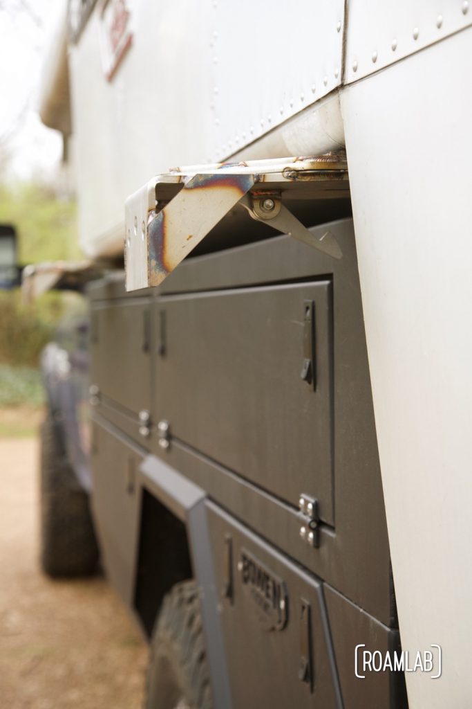 Side view of Removable jack mount bracket attached to truck camper wing and Bowen Customs truck bed.