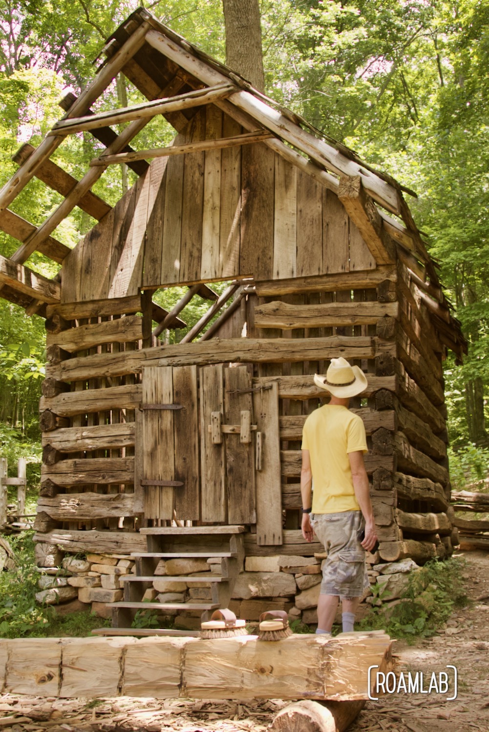 Man walking around and partially assembled wood hog crib.