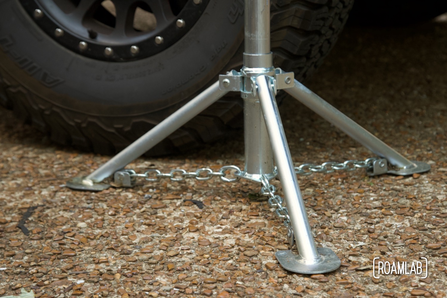 Tripod base supports a steel truck camper jack.