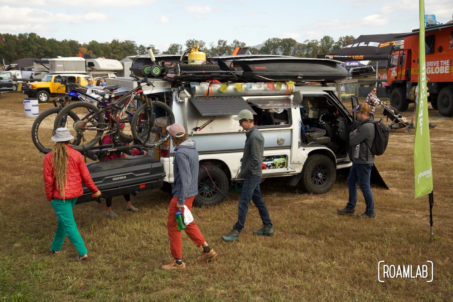 Group of Overland Expo East 2022 touring the Slacker Van in the DIY Showcase.