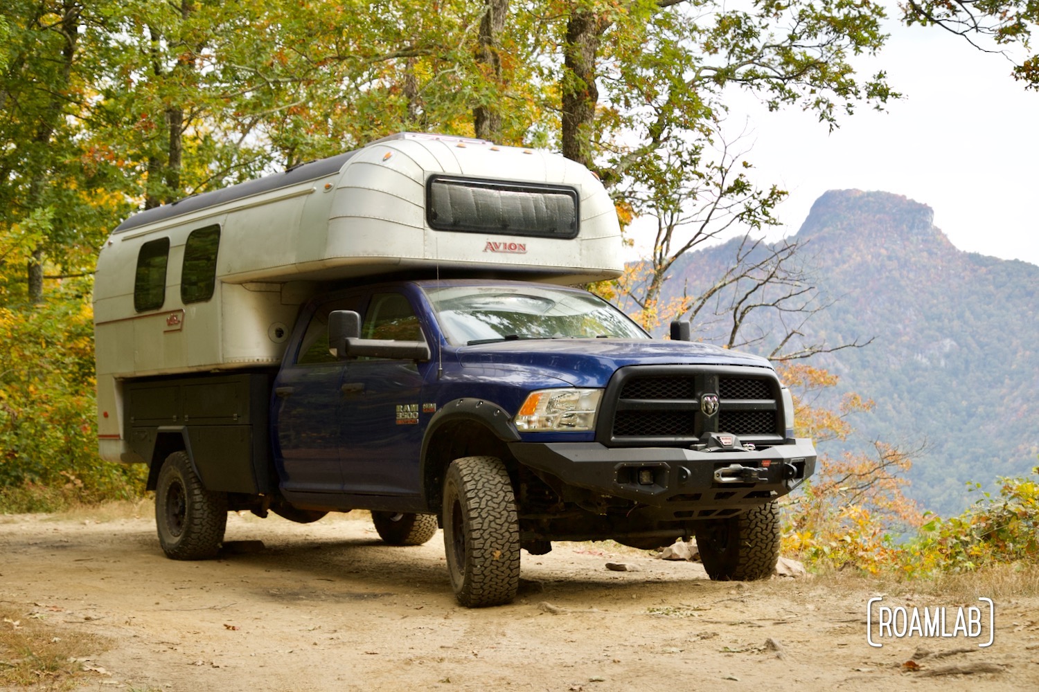 1970 Avion C11 truck camper parked in a primitive campsite with a view of Linville Gorge Wilderness Area.