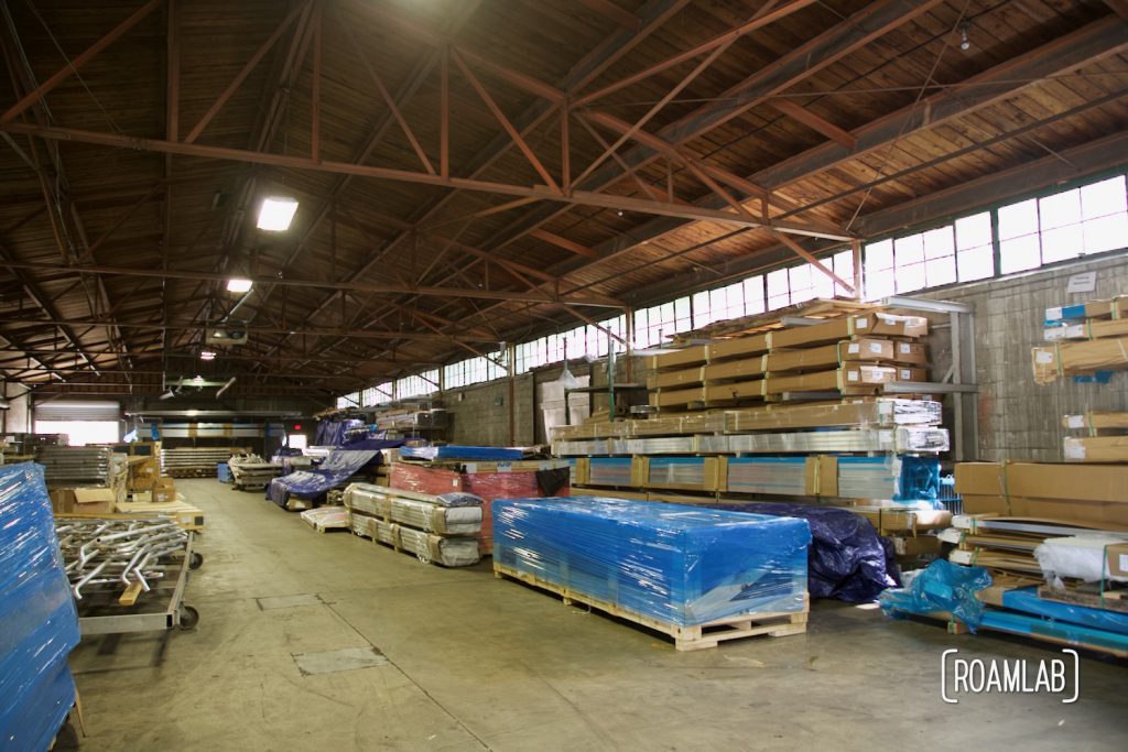 Warehouse interior view of stacked aluminum packaged for shipping.