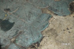 Closeup of worn green floor tiles from the original Southern Aluminum Finishing Co (SAF) offices.