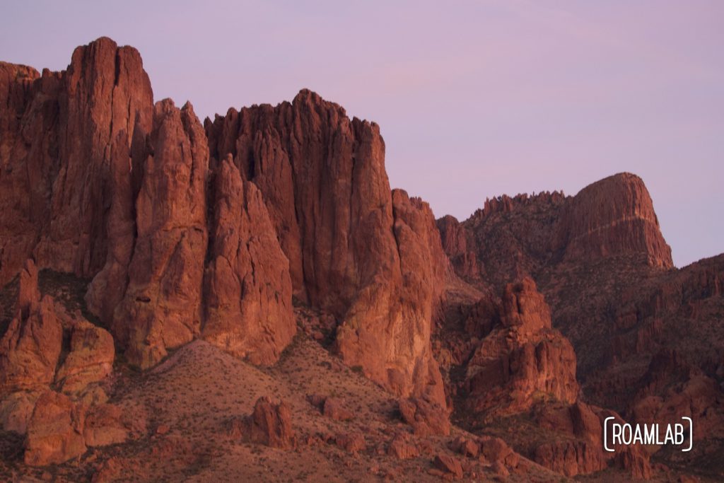 The last light of the day shining on the red rock face of the Superstition Mountains in Lost Dutchman State Park, Arizona.
