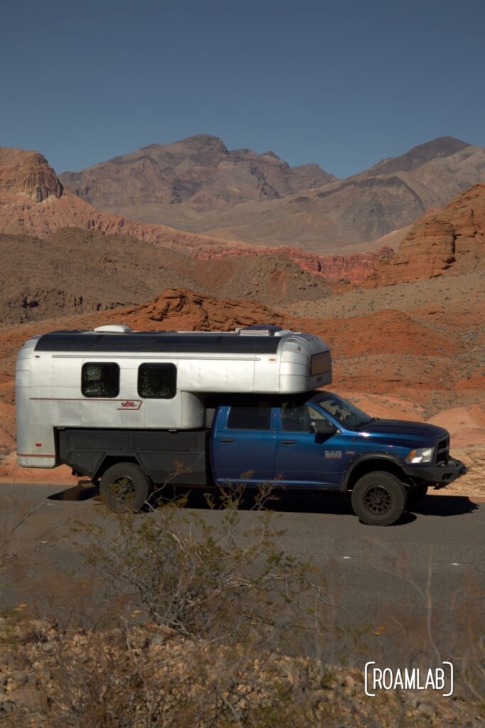 Avion C11 truck camper parked by a vista of red rock formations and desert mountains in Lake Mead National Recreation Area outside Las Vegas, Nevada.